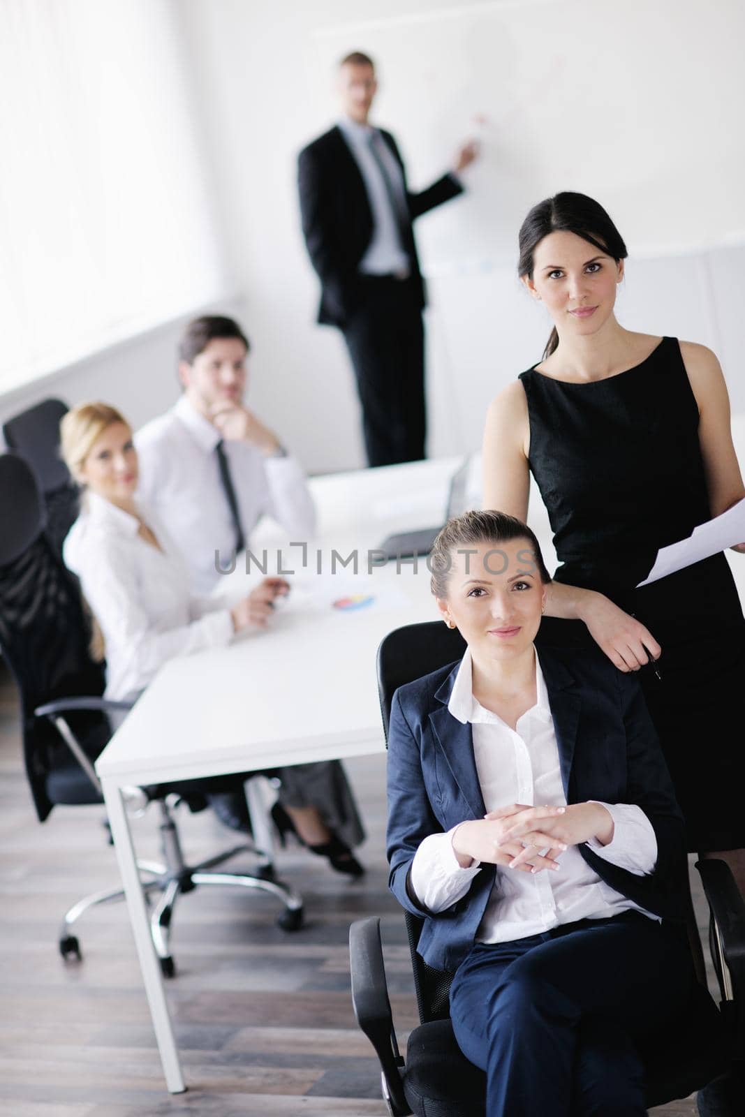 business woman  with her staff,  people group in background at modern bright office indoors