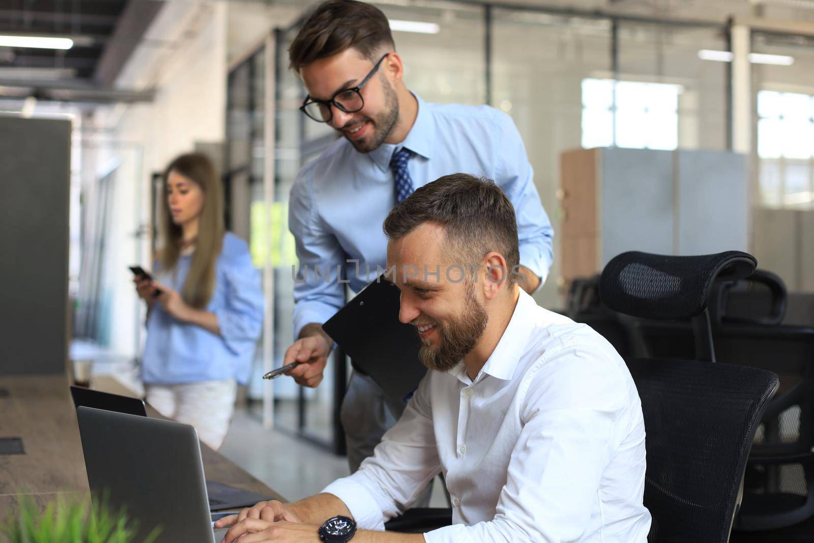 Group of young modern people discussing business in the office