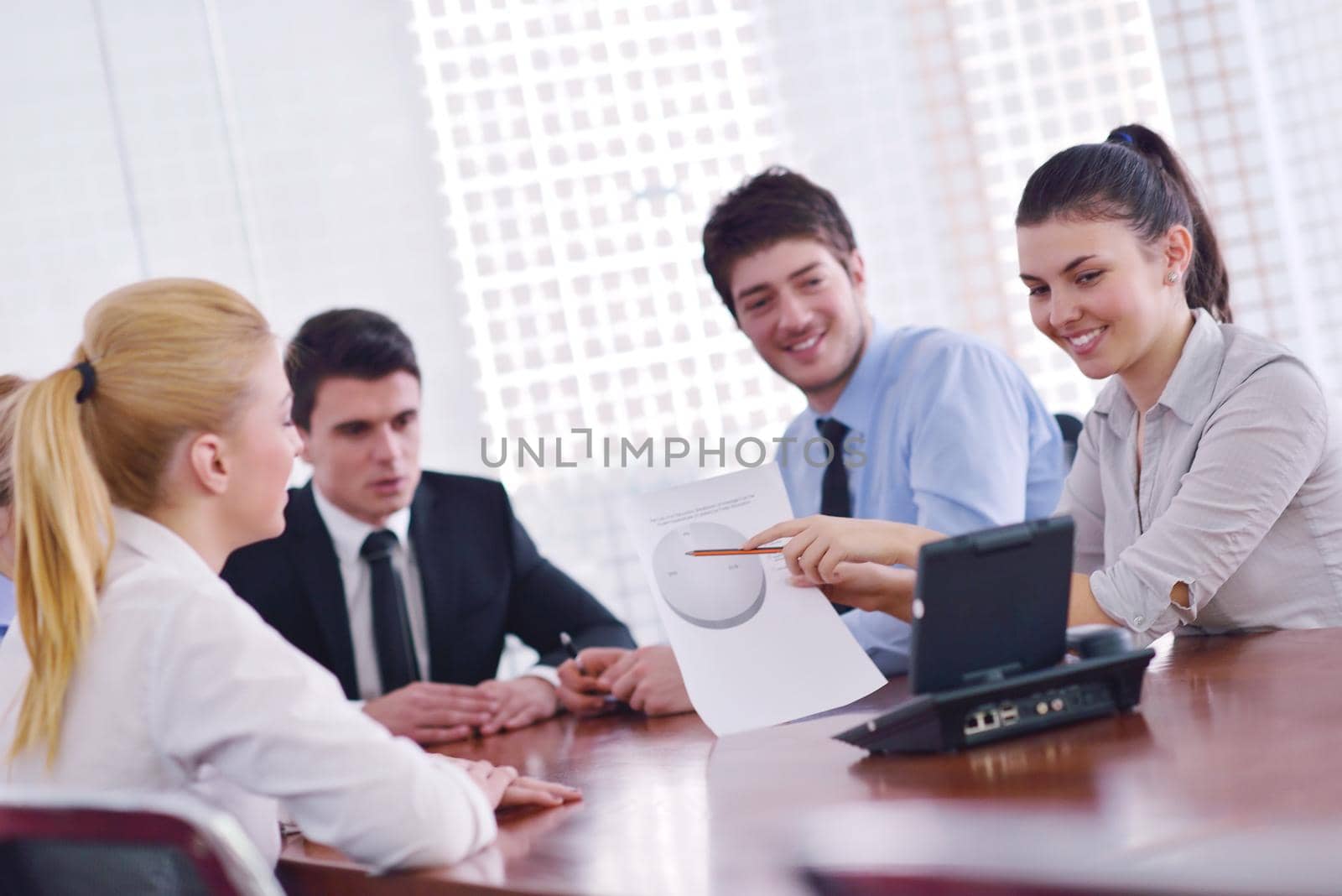 Group of happy young  business people in a meeting at office