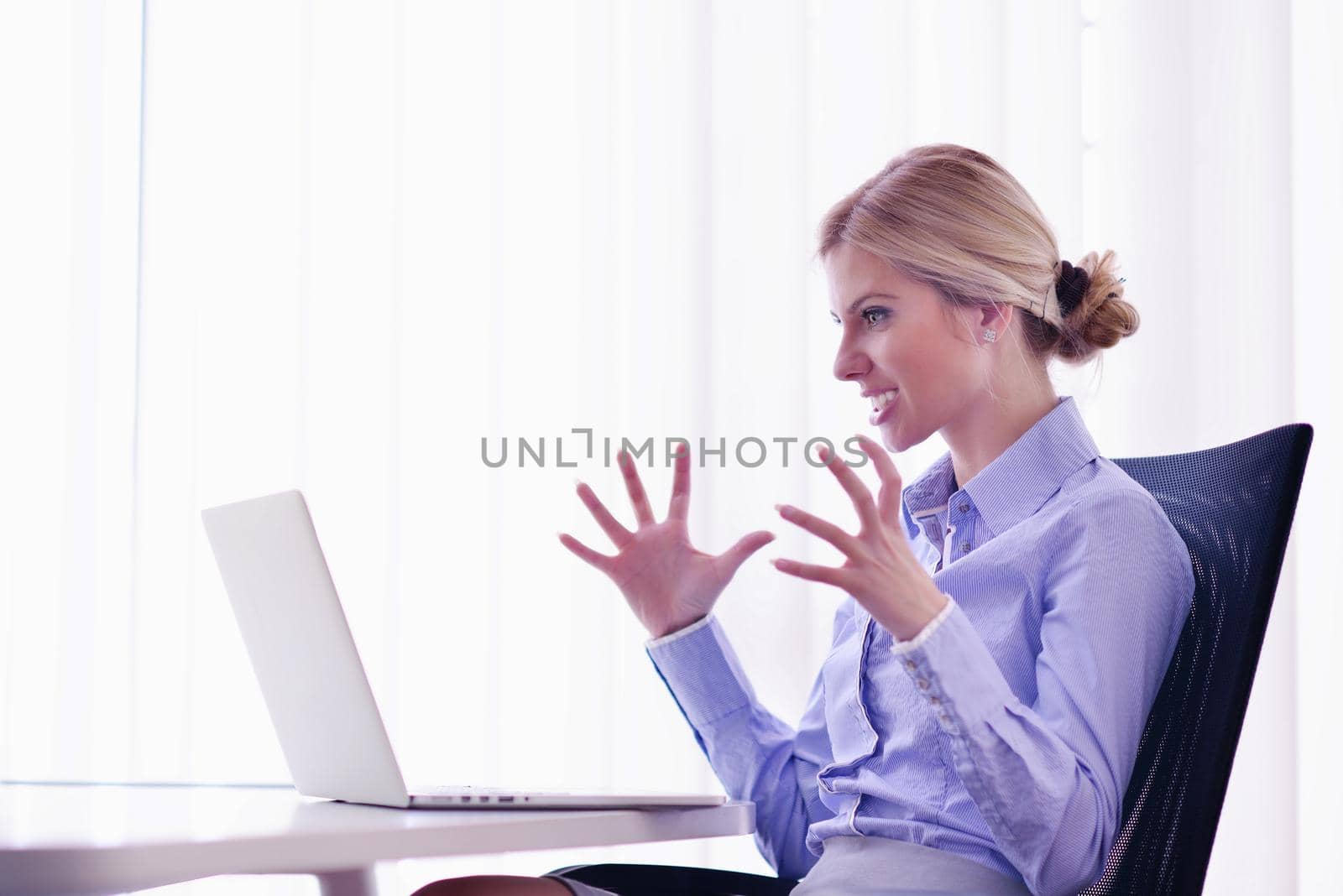 portrait of Young pretty business woman work on  notebook computer  in the bright modern office indoors