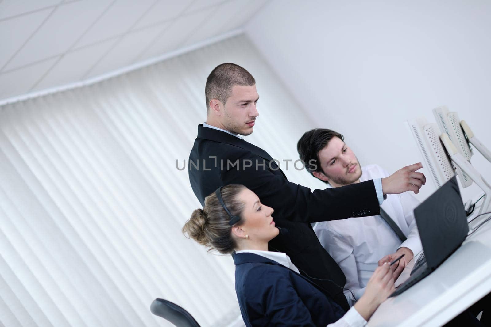 business people group with  headphones giving support in  help desk office to customers, manager giving training and education instructions