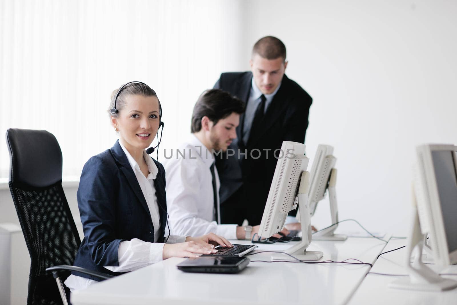 business people group with  headphones giving support in  help desk office to customers, manager giving training and education instructions