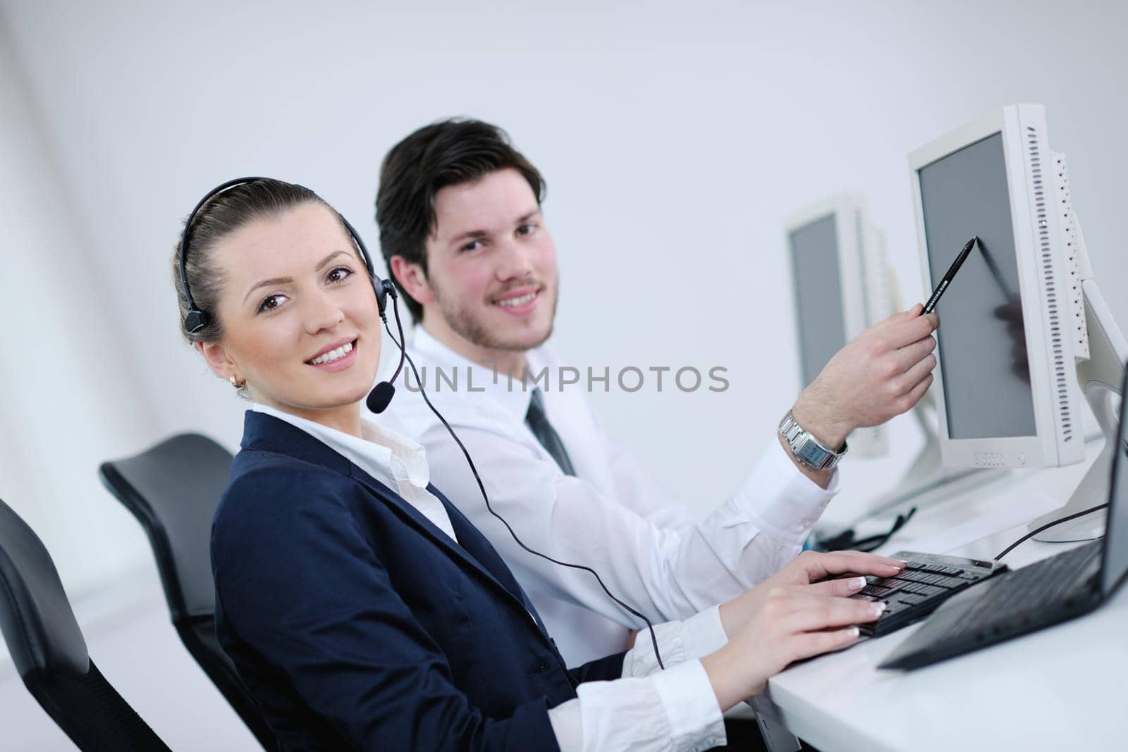 business people group with  headphones giving support in  help desk office to customers, manager giving training and education instructions