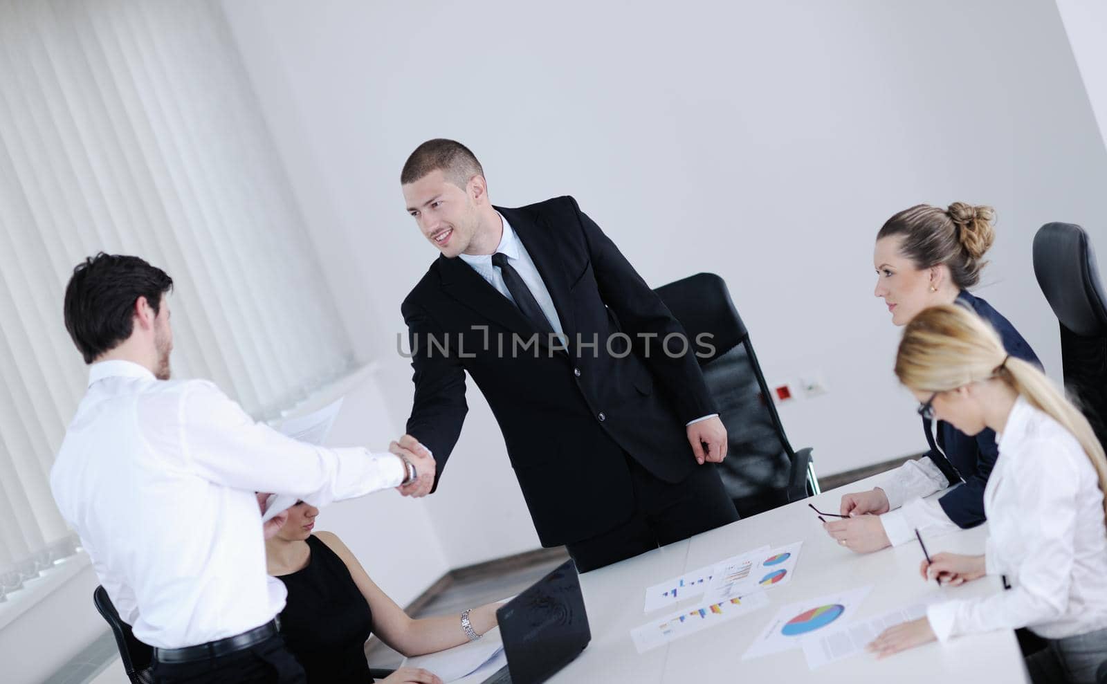 Group of happy young  business people in a meeting at office