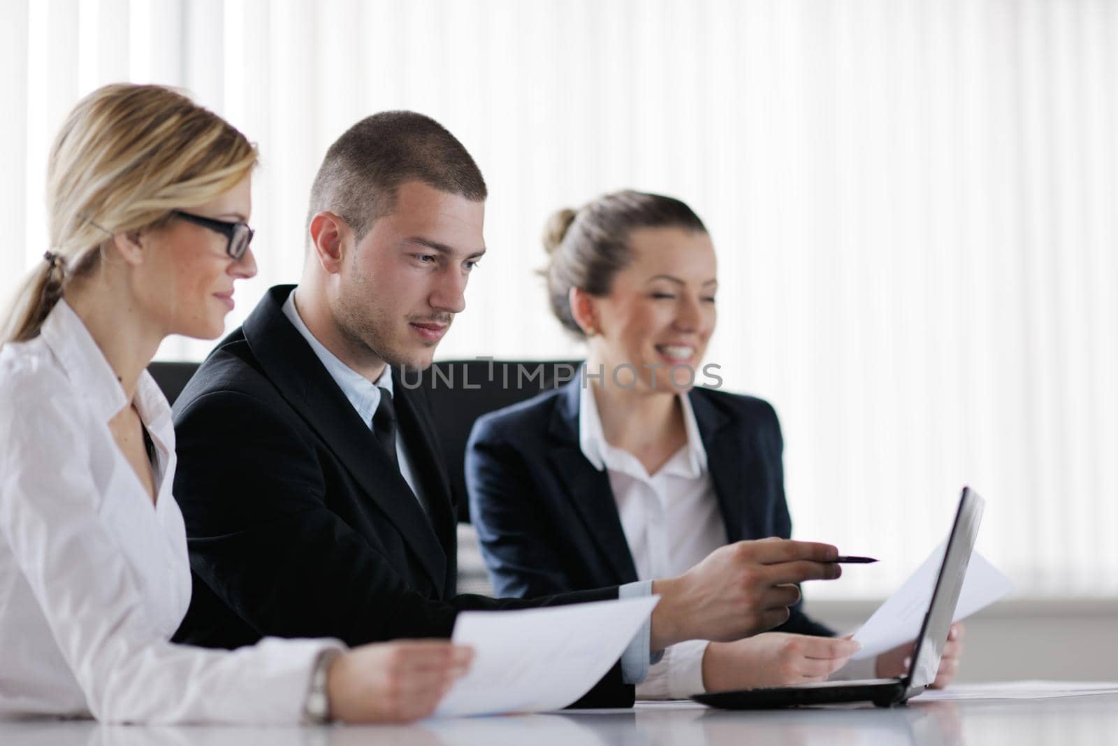 Group of happy young  business people in a meeting at office