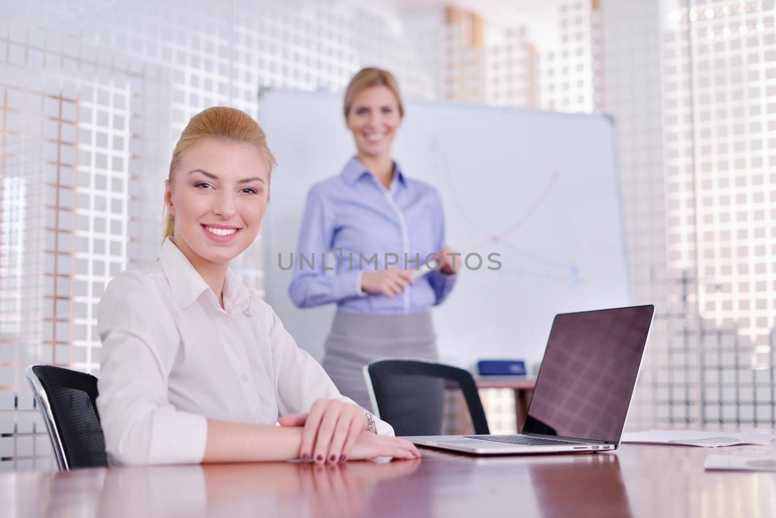 business woman  with her staff,  people group in background at modern bright office indoors