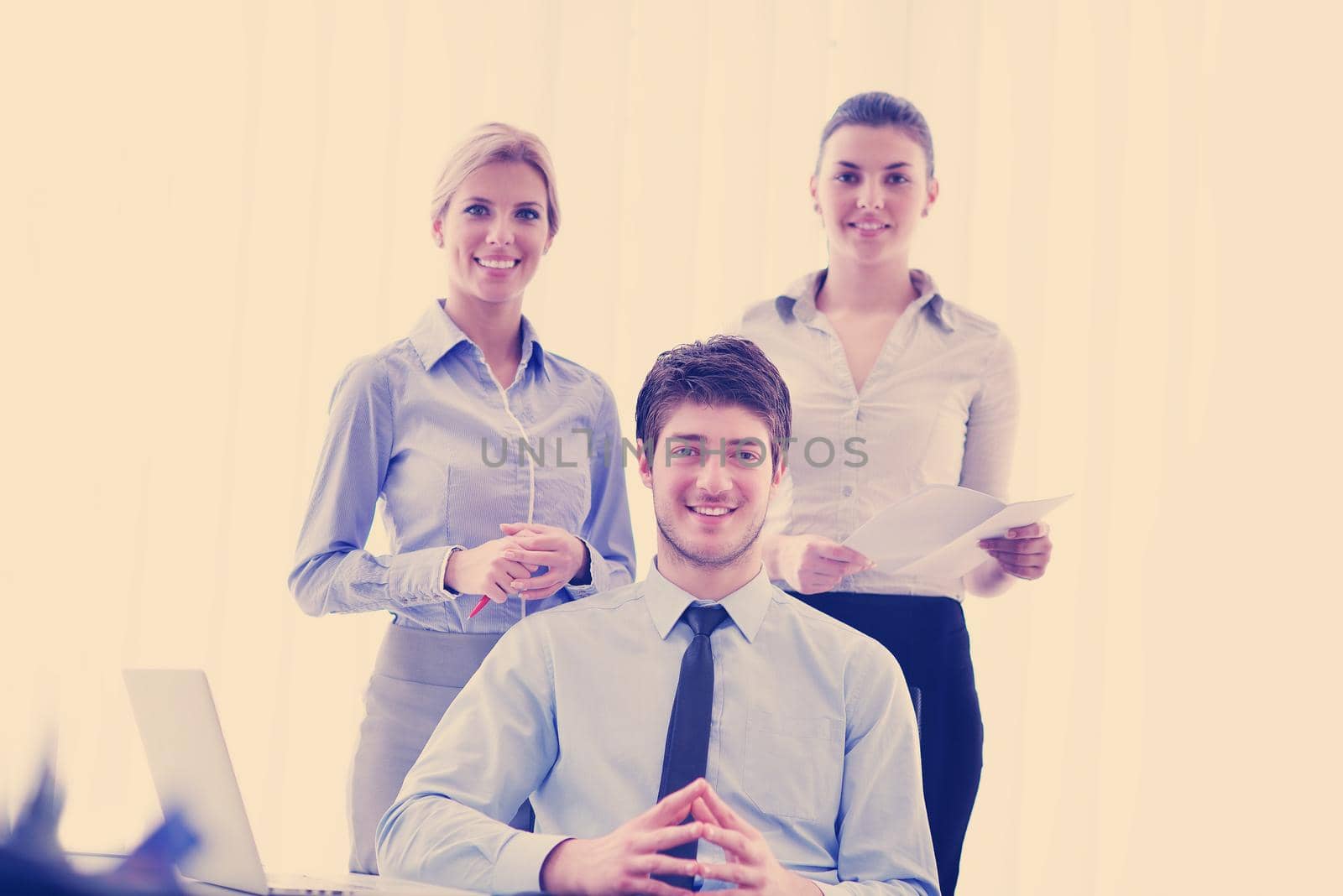 Group of happy young  business people in a meeting at office