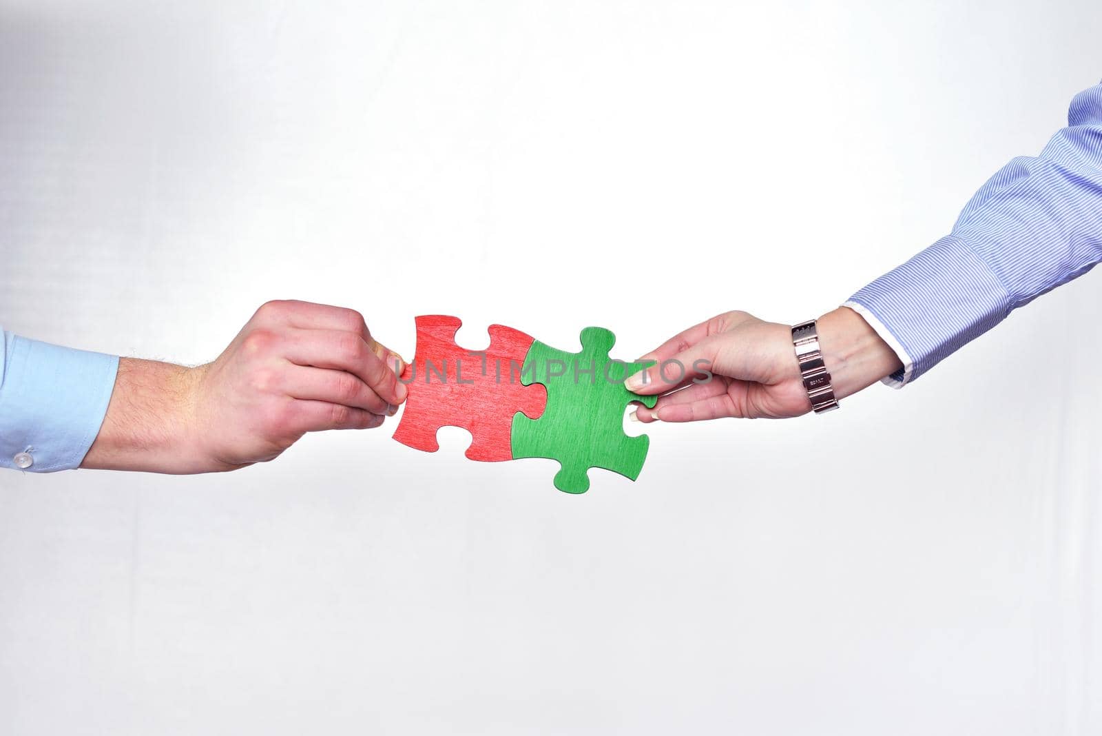 Group of business people assembling jigsaw puzzle by dotshock