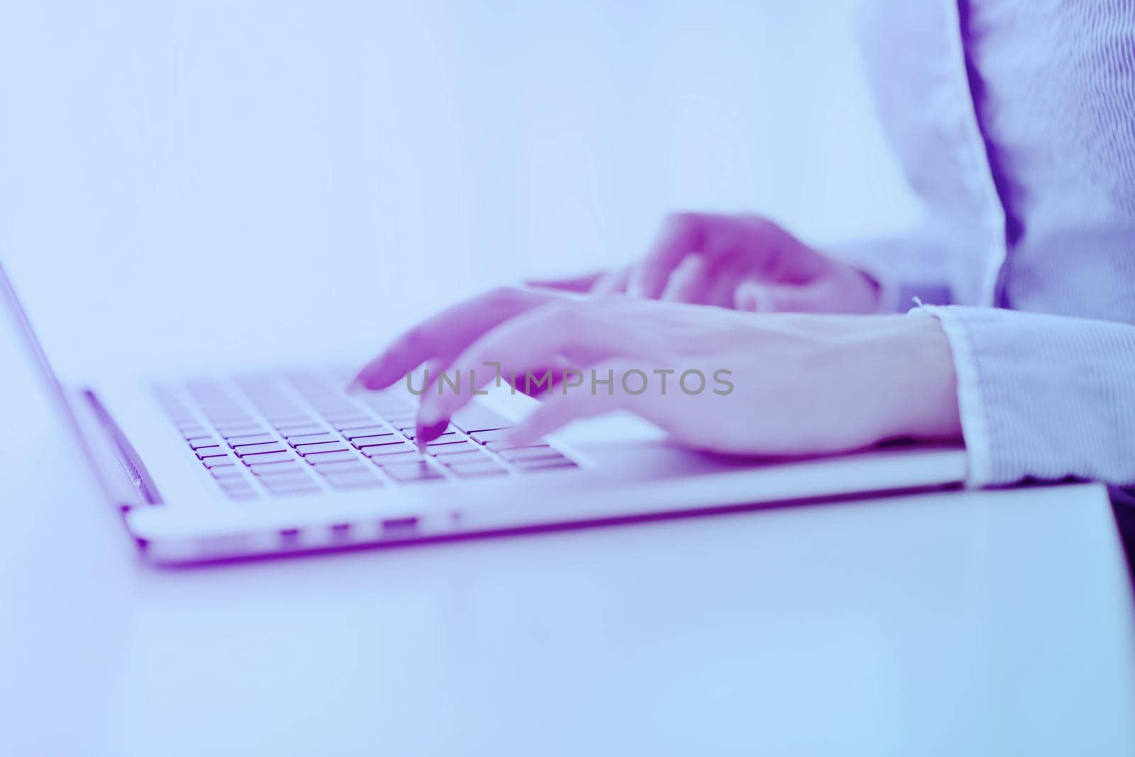 portrait of Young pretty business woman work on  notebook computer  in the bright modern office indoors