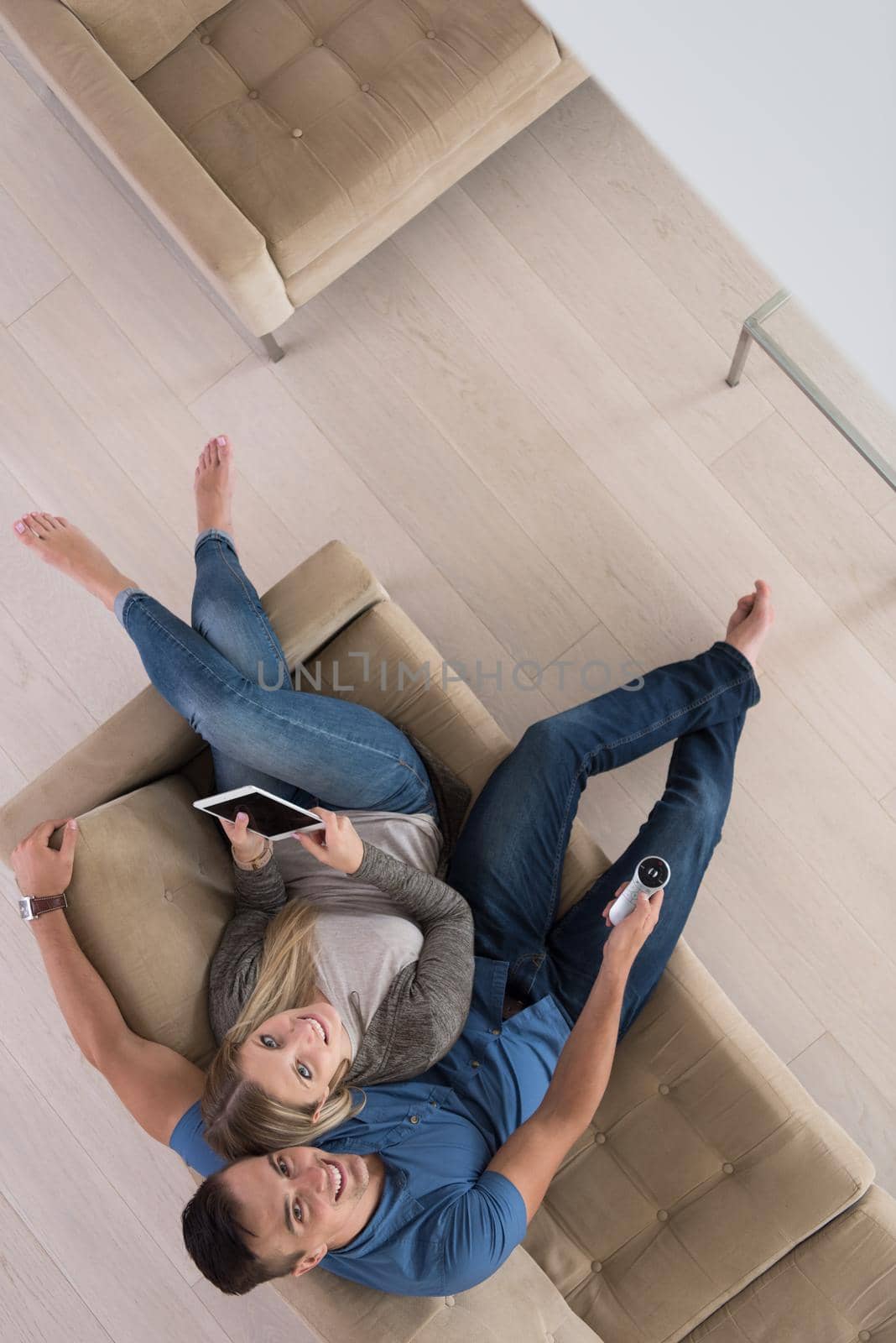 youg couple in living room with tablet top view by dotshock