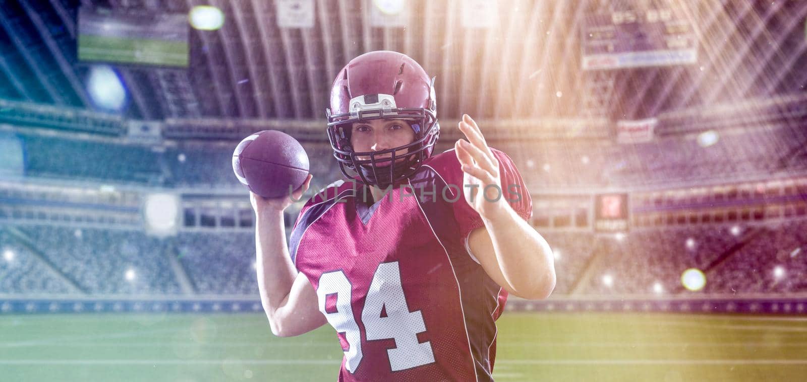 one quarterback american football player throwing ball on big modern stadium with lights and flares