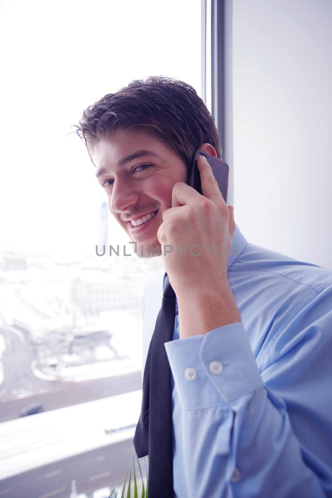 business man talking by cellphone in office