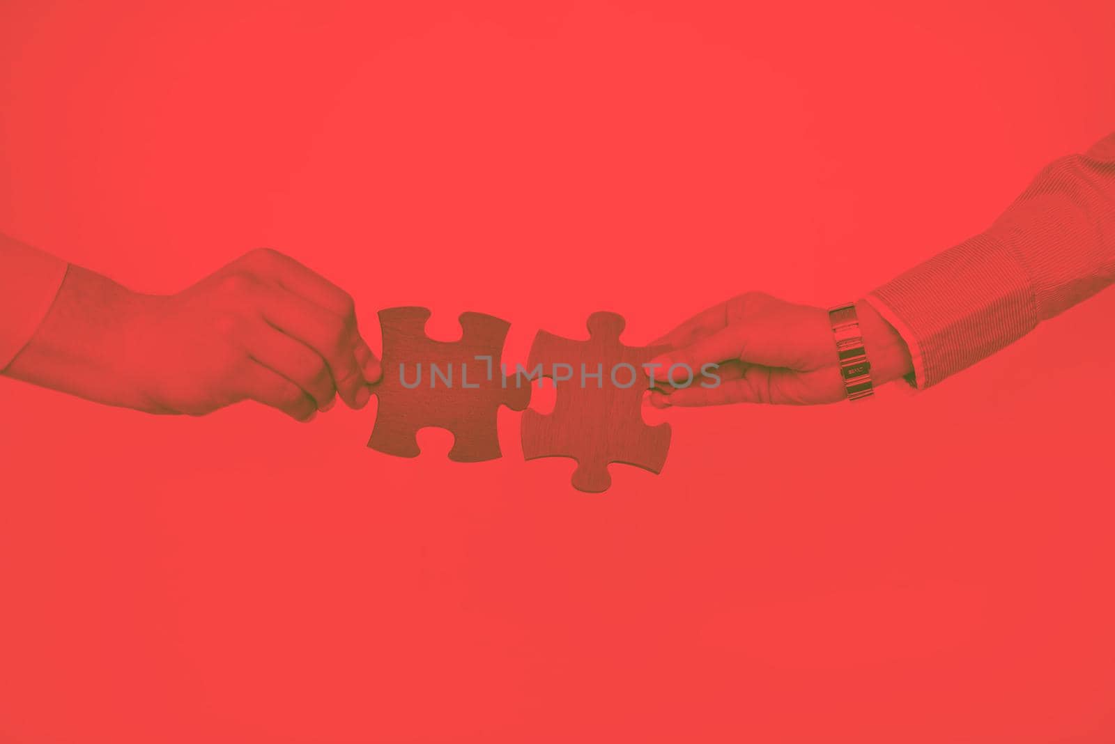 Group of business people assembling jigsaw puzzle by dotshock