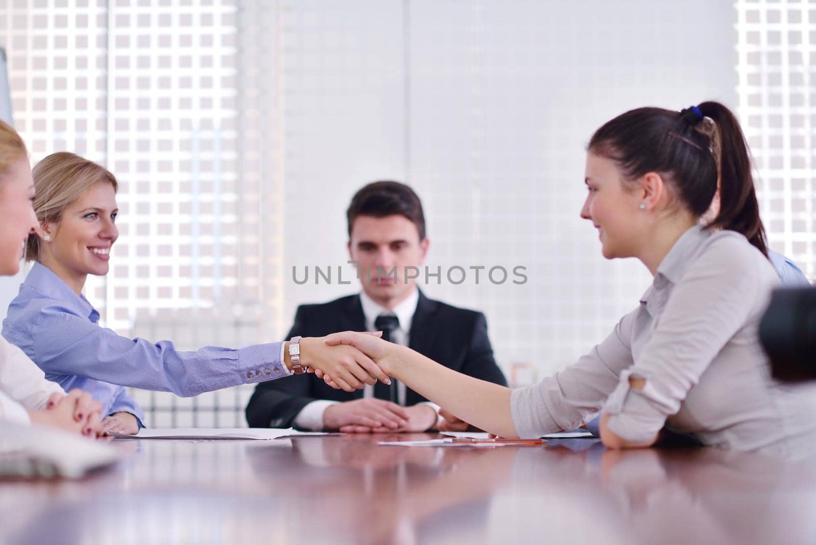 Group of happy young  business people in a meeting at office