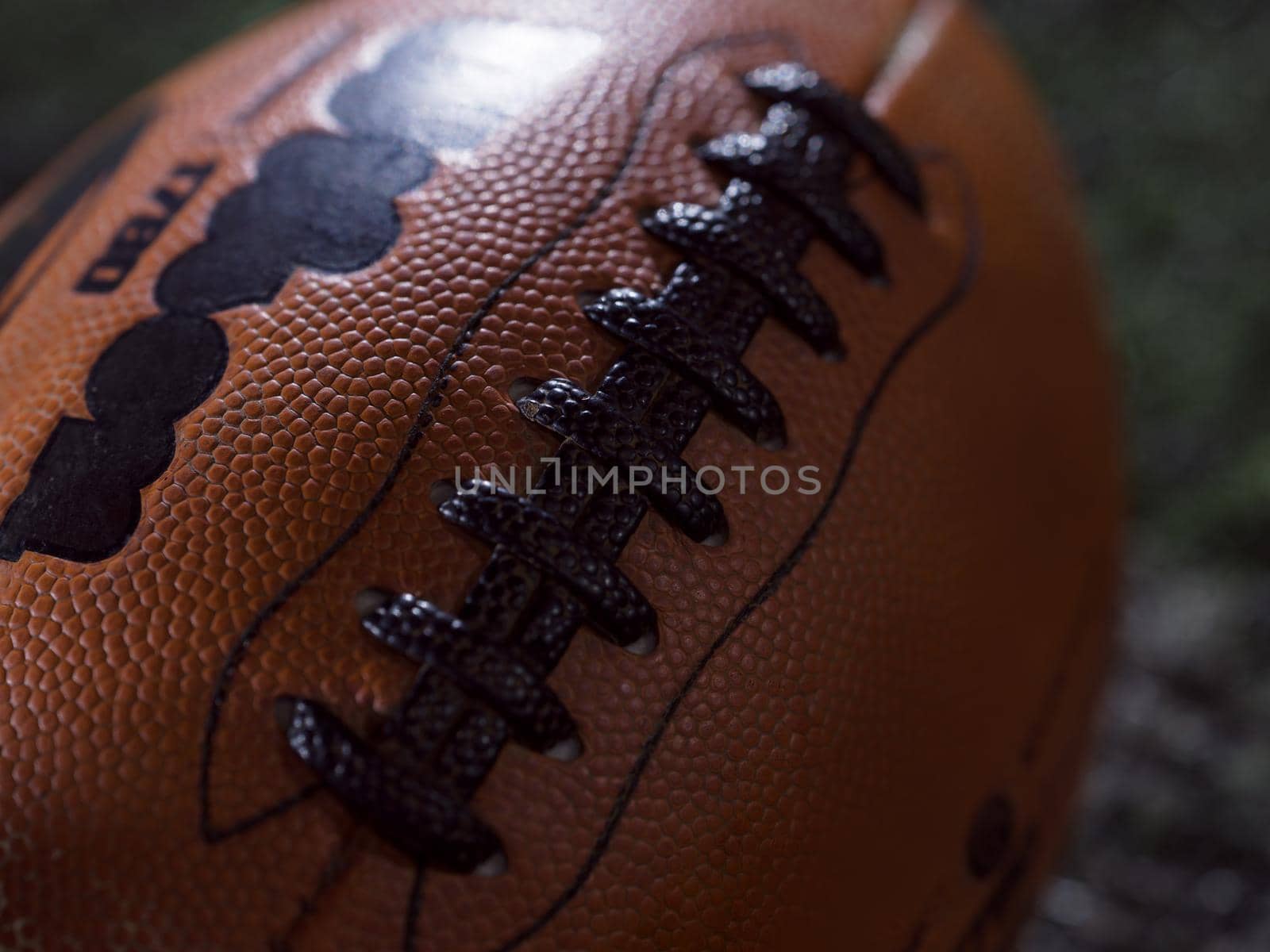 closeup shot of american football on the night field