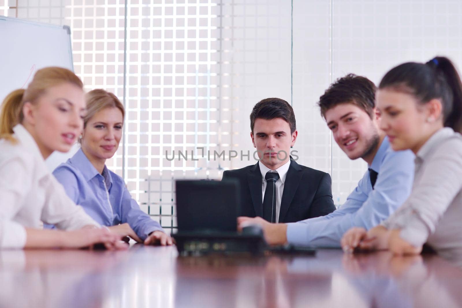 Group of happy young  business people in a meeting at office