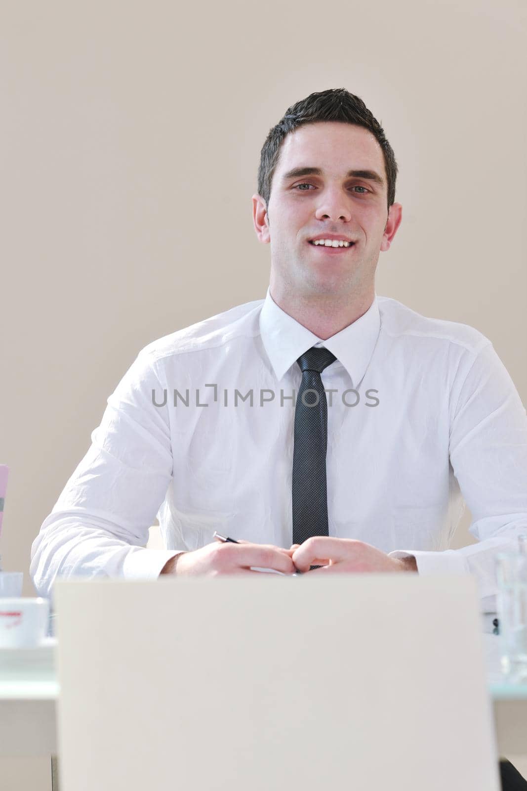 young business man alone in conference room by dotshock