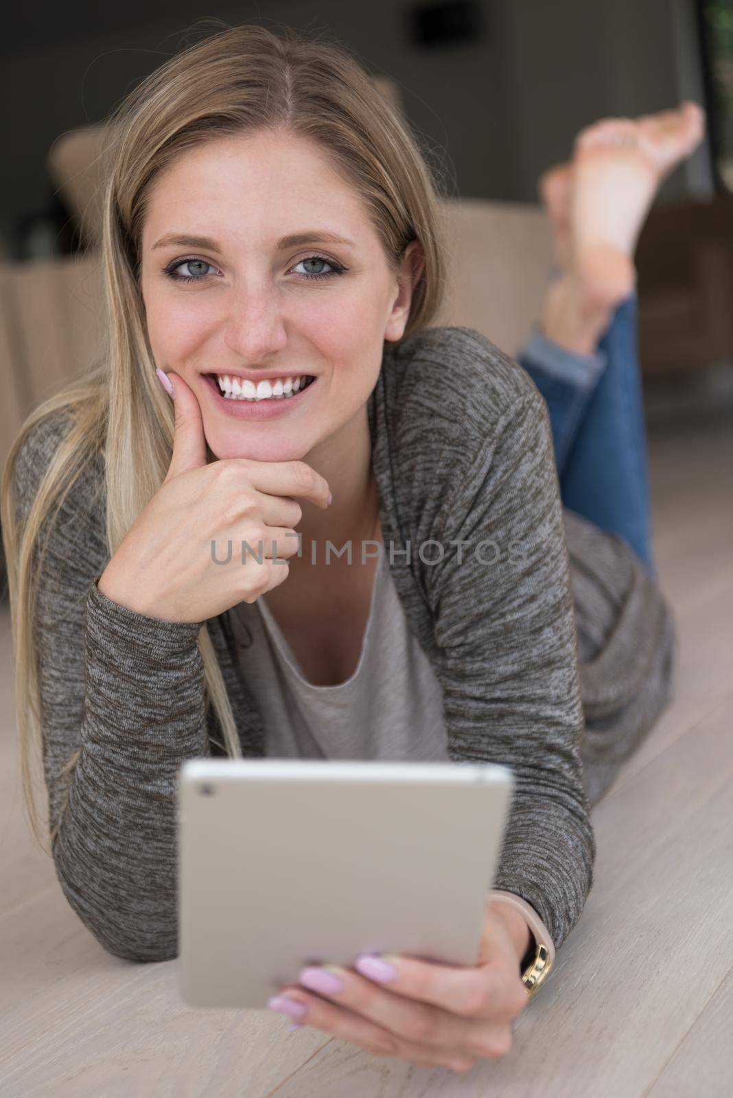 beautiful young women used tablet computer on the floor of her luxury home
