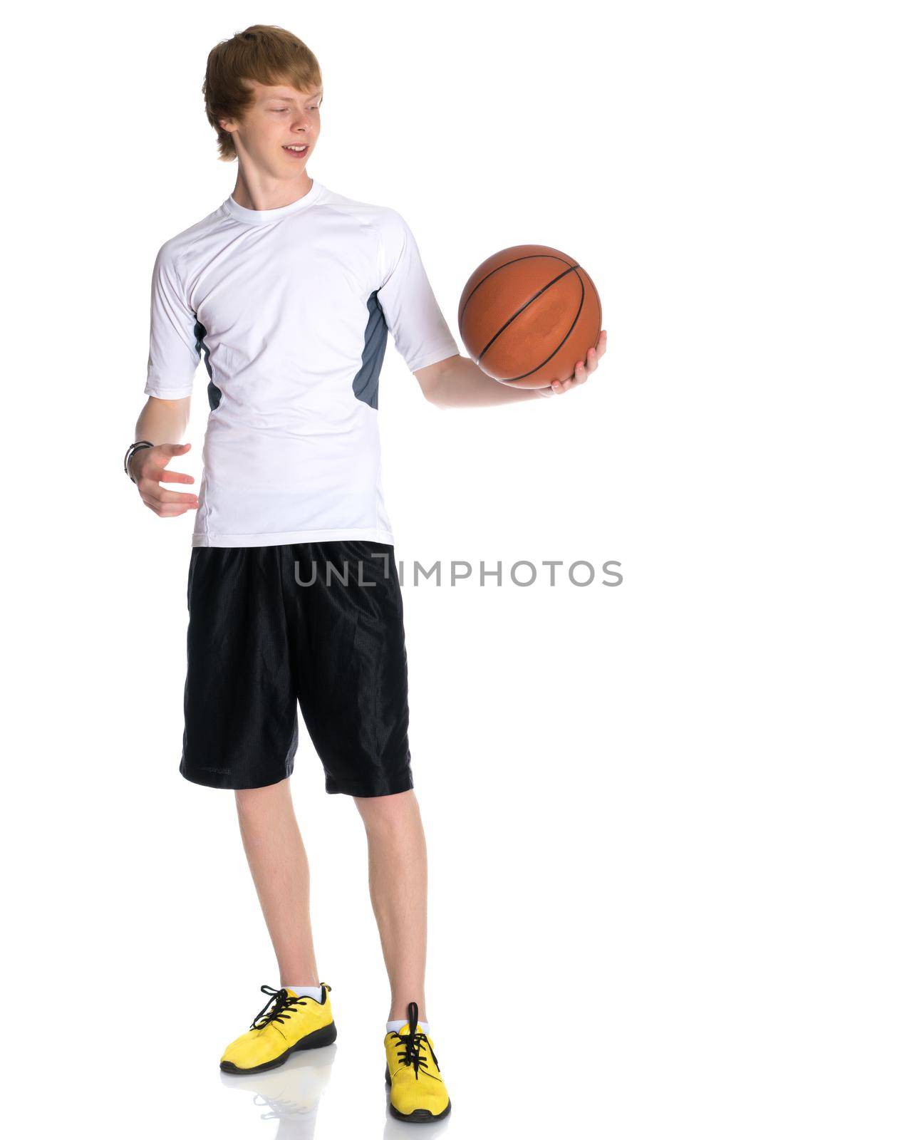 A young red-haired guy playing basketball. The concept of sport, fitness, healthy lifestyle. Isolated on white background.