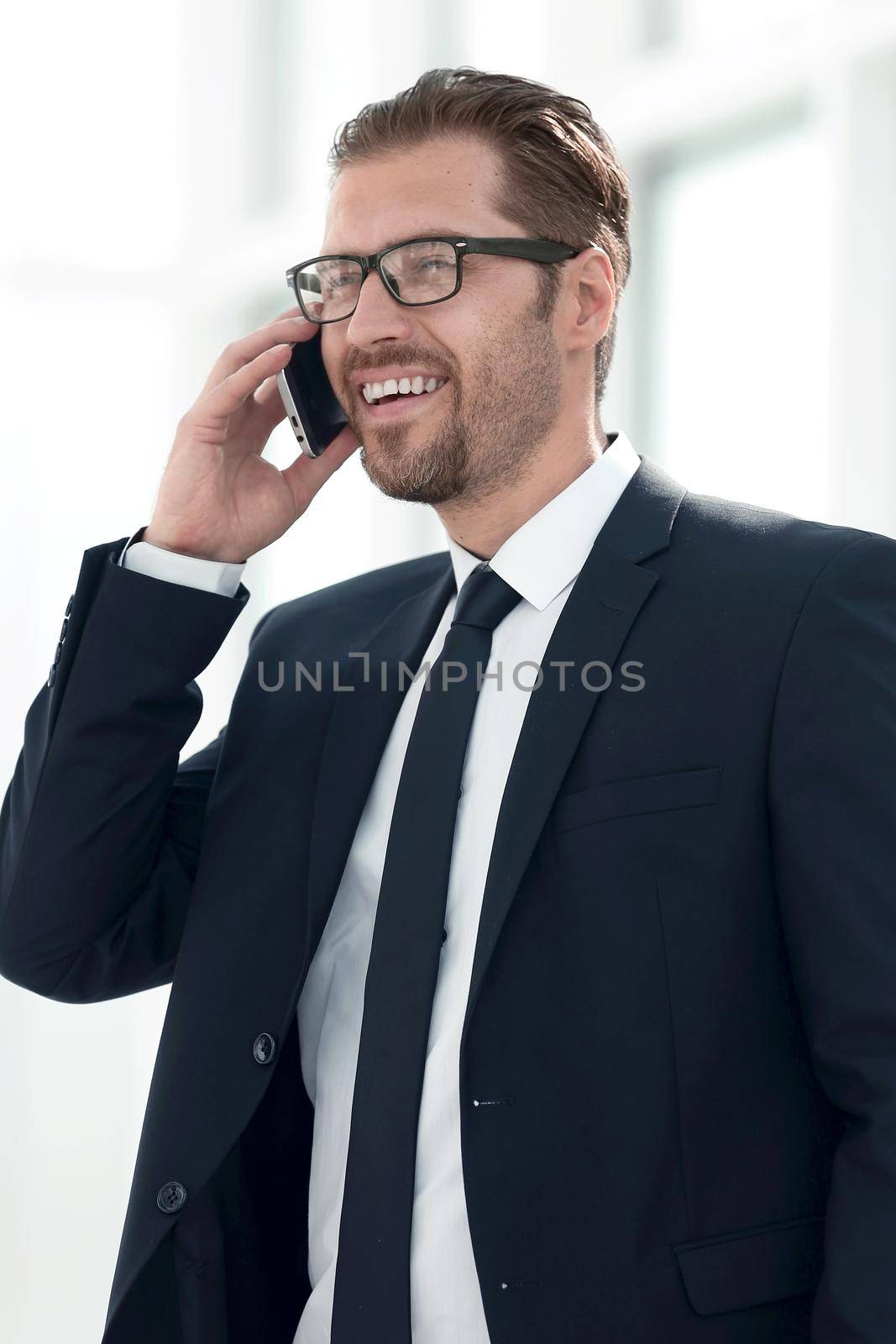 confident businessman talking on mobile phone. by asdf