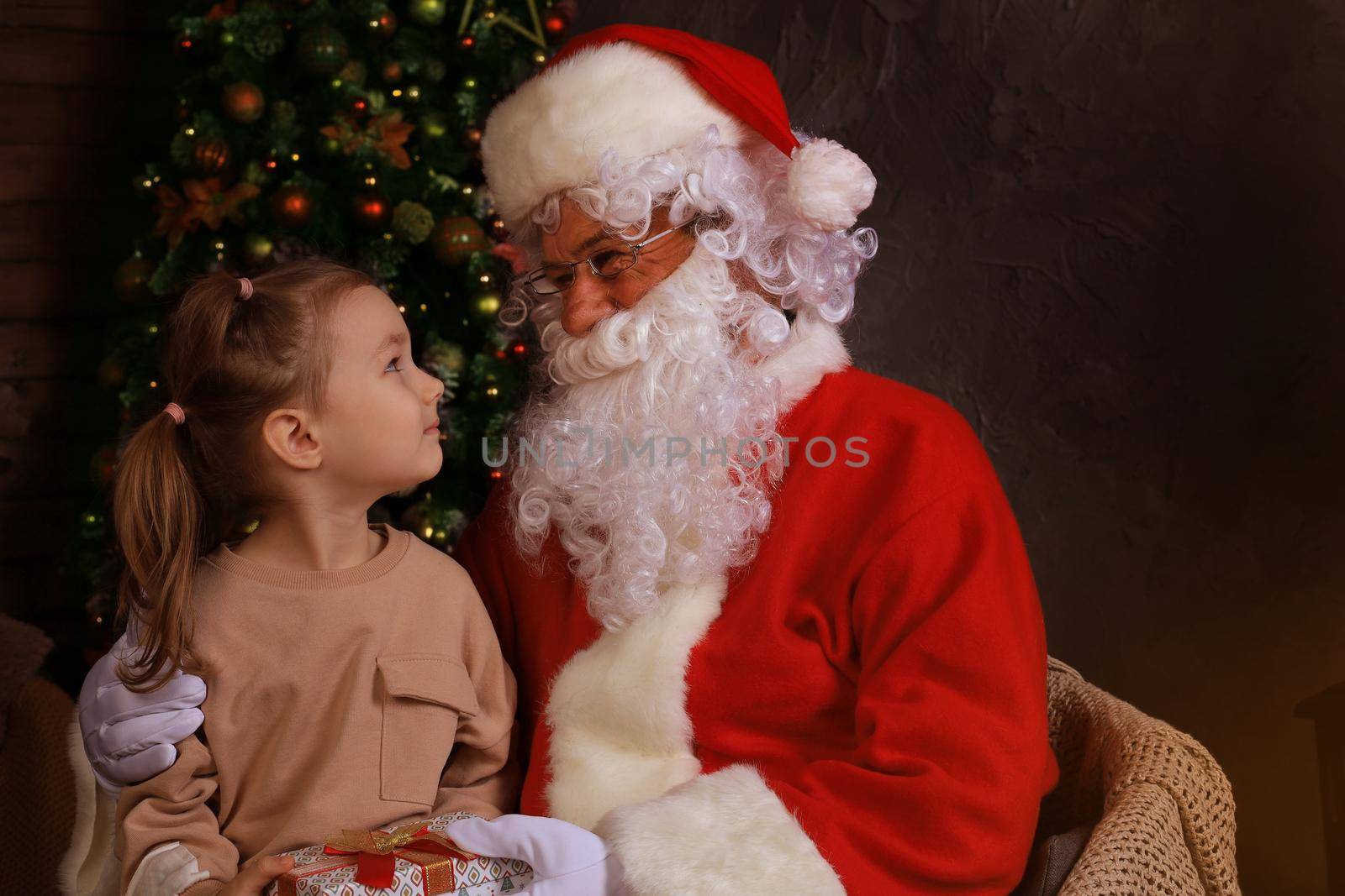 Santa Claus and child at home. Christmas gift. Family holiday concept