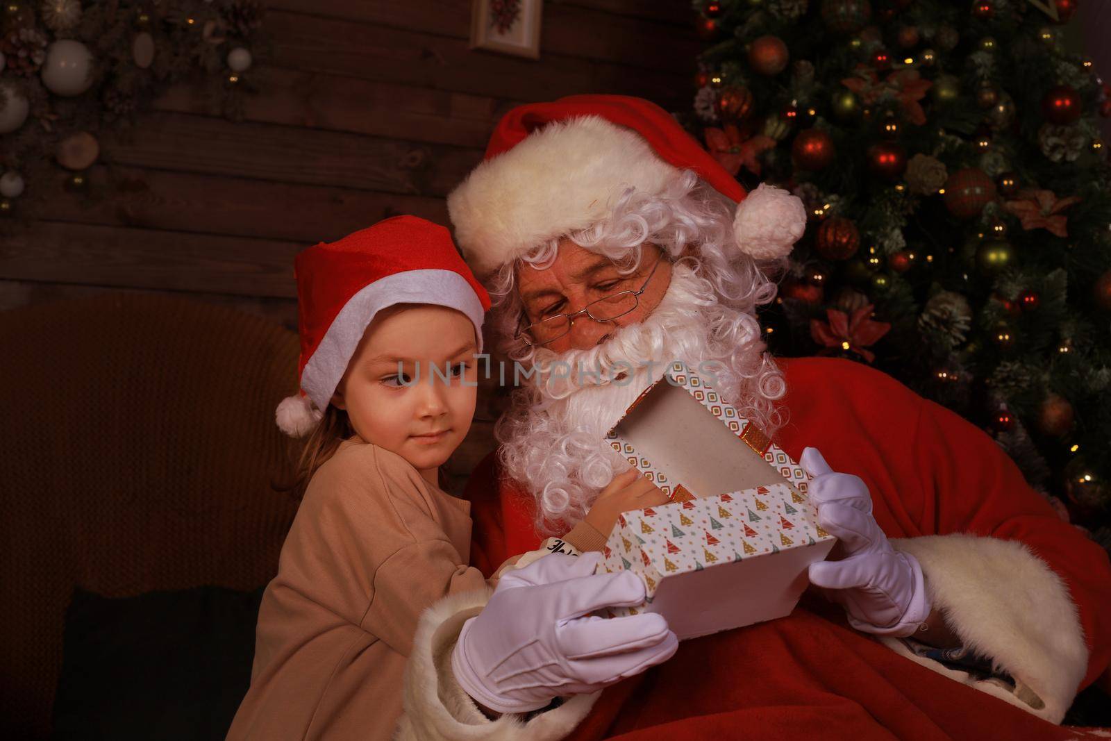 Santa Claus and child at home. Christmas gift. Family holiday concept. by tsyhun