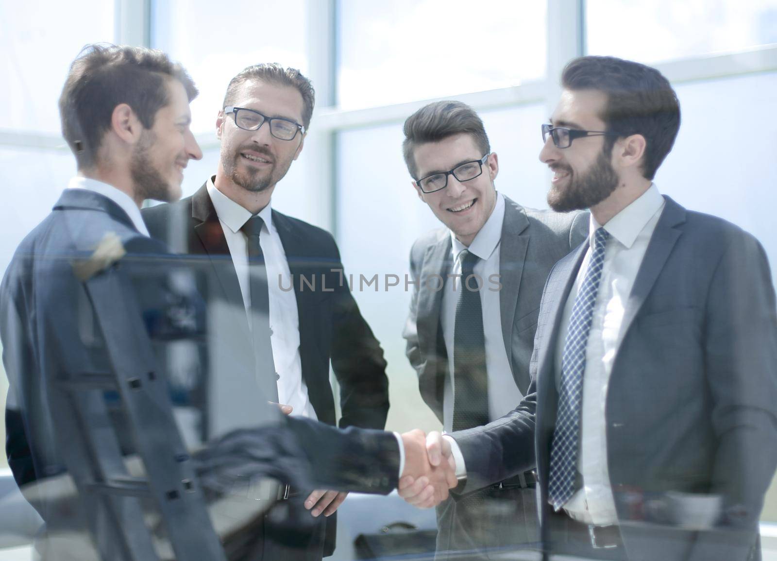 business partners shaking hands in the lobby of the business center.business concept
