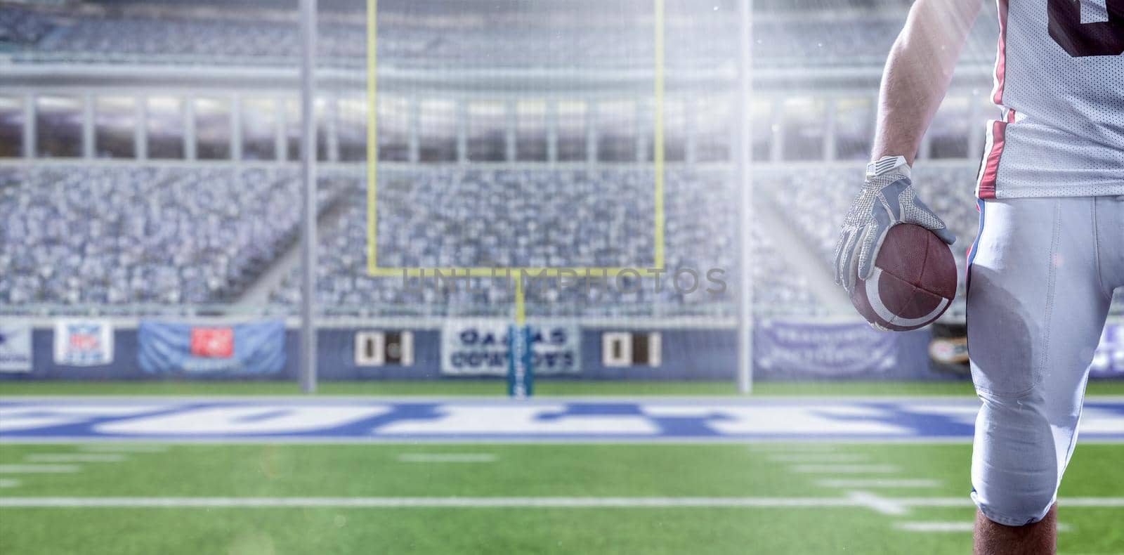 Closeup Portrait of a strong muscular American Football Player on big modern stadium field with lights and flares