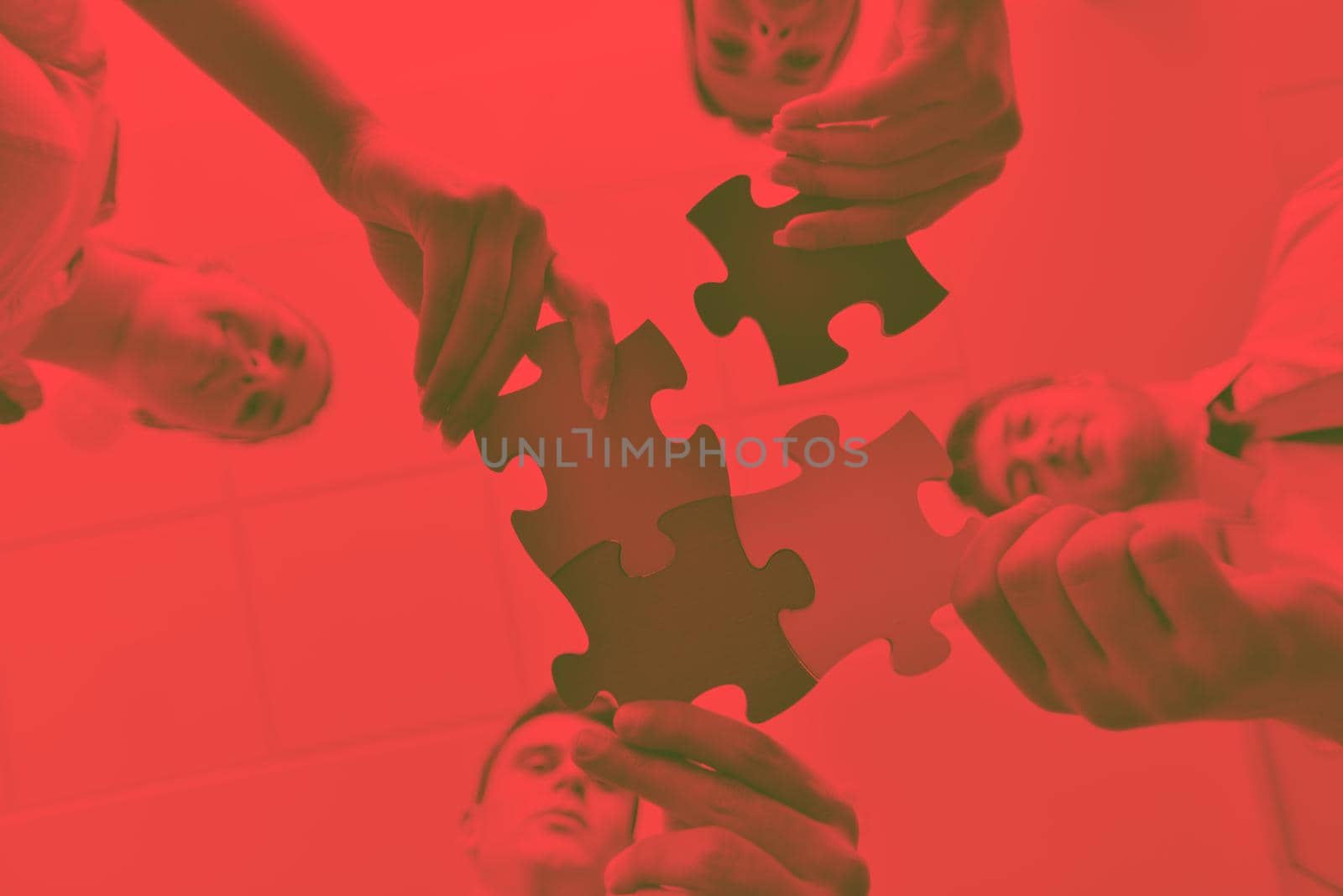 Group of business people assembling jigsaw puzzle by dotshock