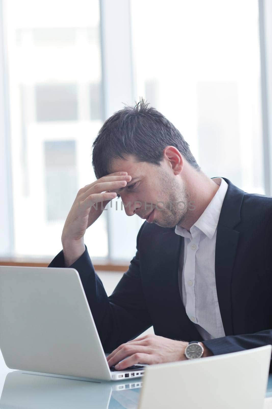 young business man lawyer with laptop alone in big bright   conference room