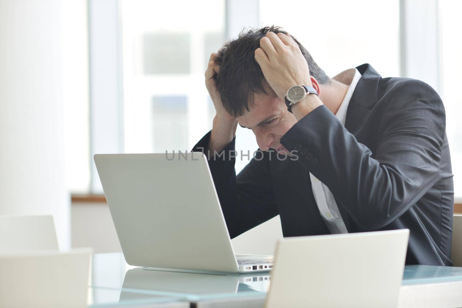 young business man alone in conference room by dotshock