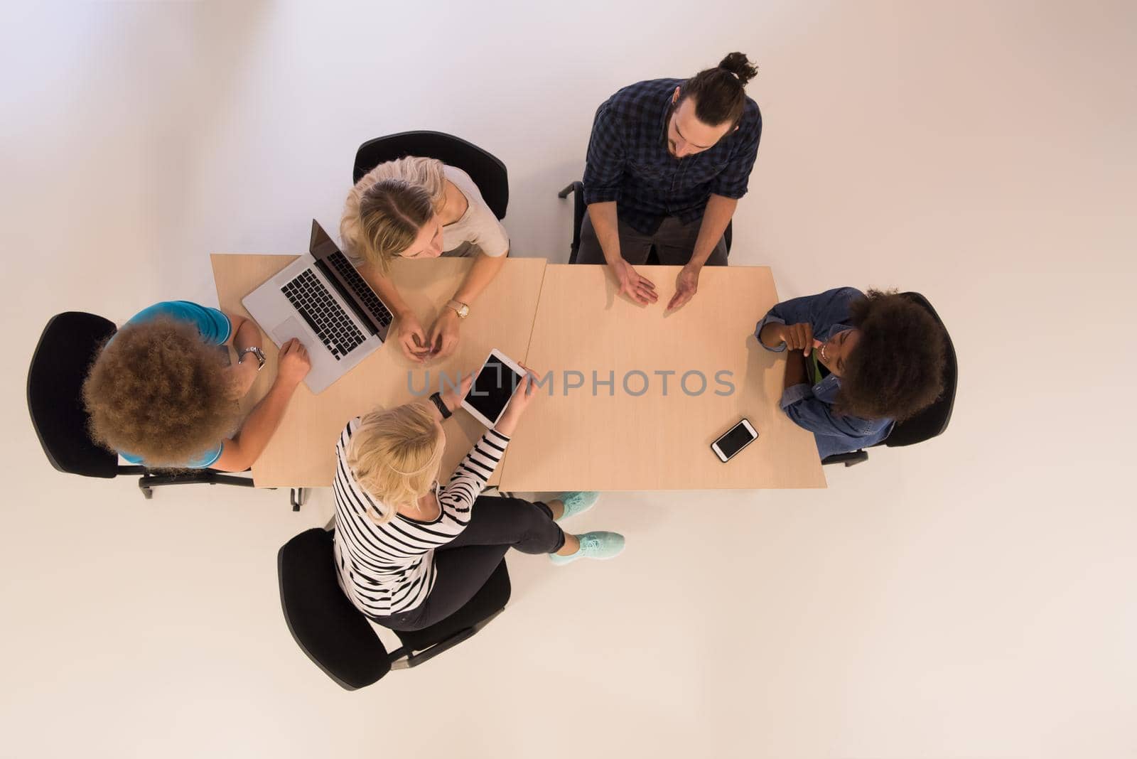 Multiethnic startup business team on meeting  top view by dotshock