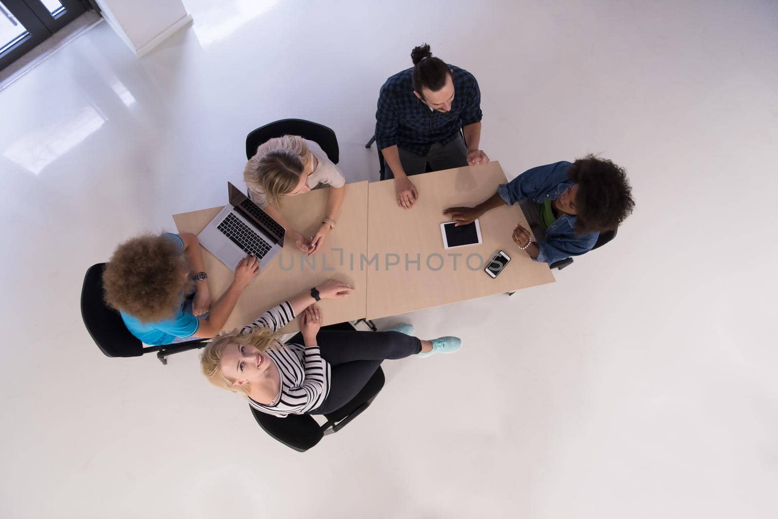 Multiethnic startup business team on meeting  top view by dotshock