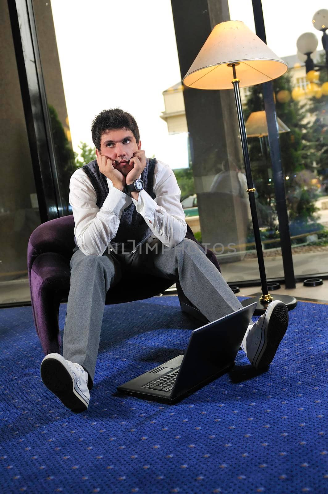 young businessman working on laptop by dotshock
