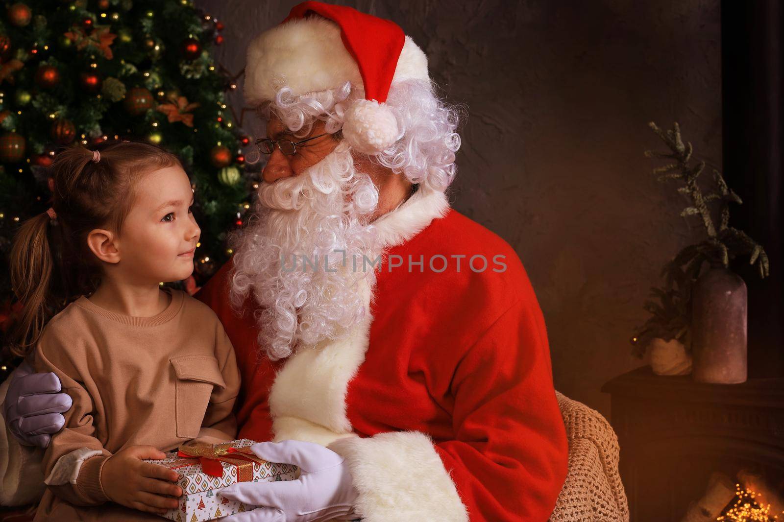 Santa Claus and child at home. Christmas gift. Family holiday concept