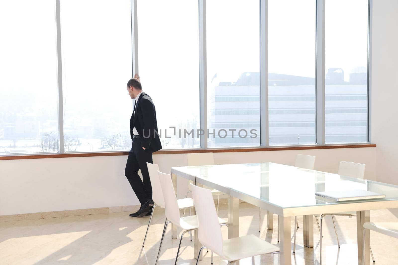 young business man alone in conference room by dotshock