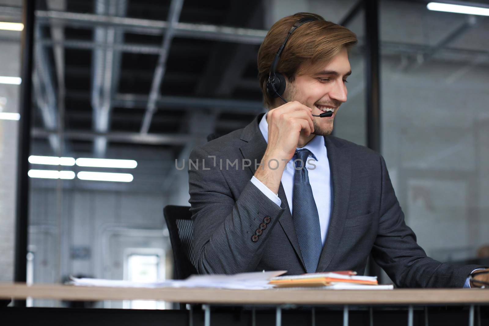 Smiling friendly handsome young male call centre operator