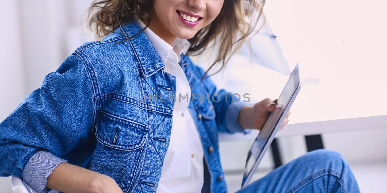 Image of a confident young woman sitting at working desk by lenets