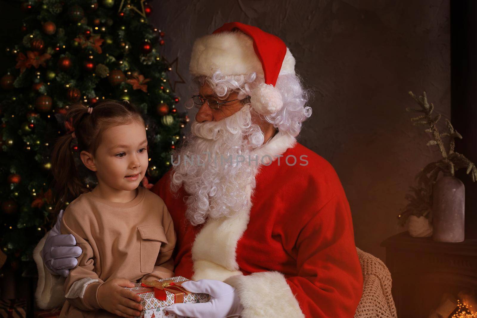 Santa Claus and child at home. Christmas gift. Family holiday concept