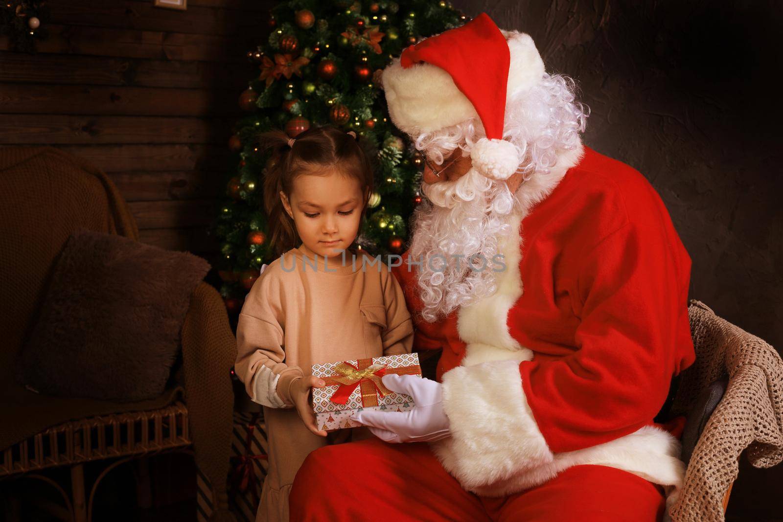 Santa Claus and child at home. Christmas gift. Family holiday concept