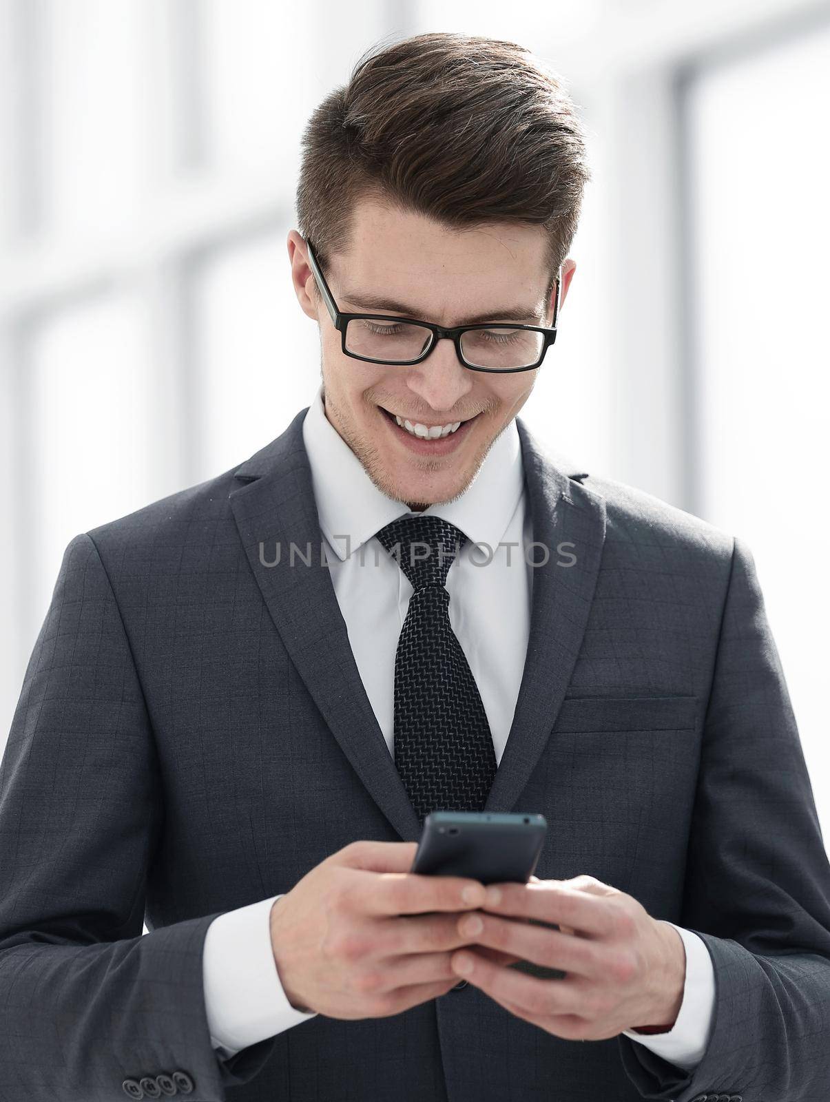 serious young businessman reading SMS by asdf