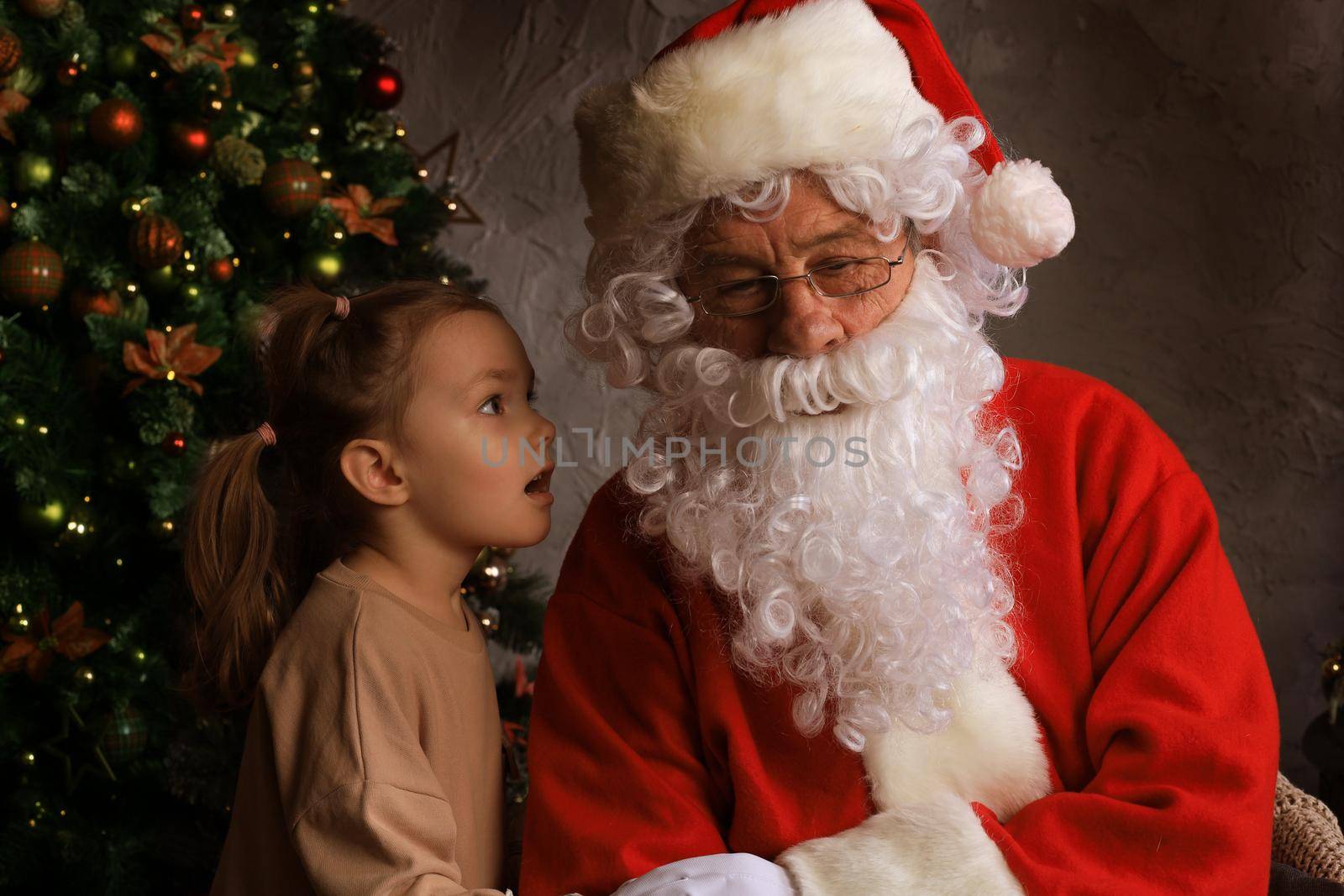 Santa Claus and child at home. Christmas gift. Family holiday concept