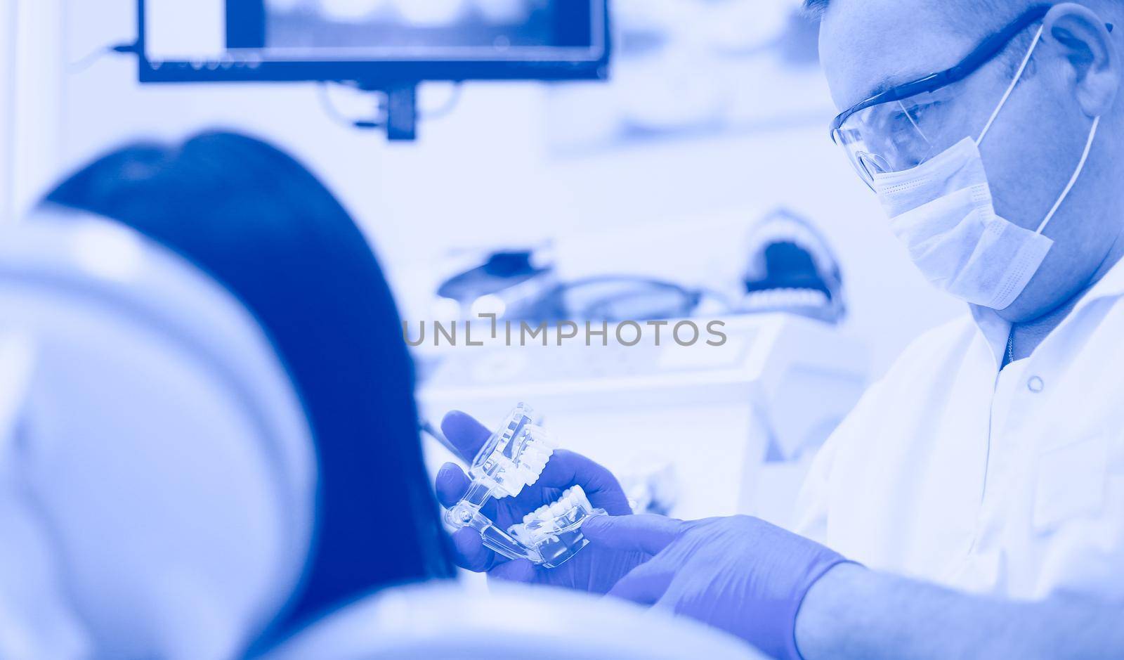 Beautiful senior woman at dentist having dental treatment at dentist's office.