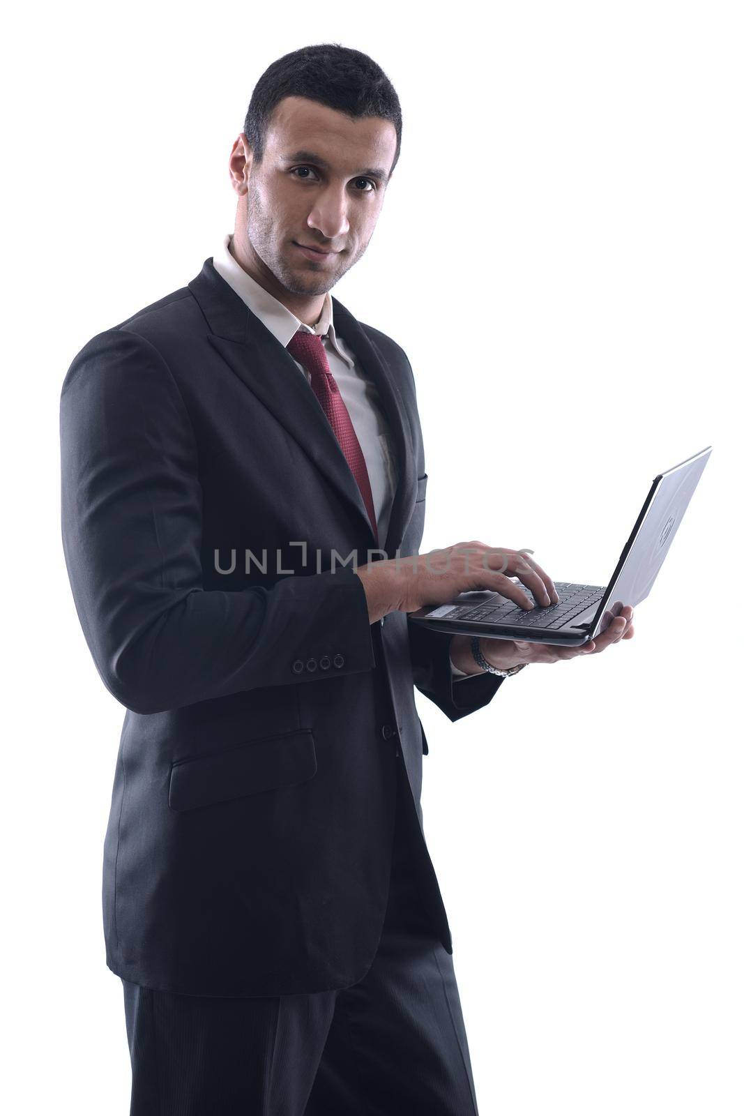 Smiling business man hold and work on mini laptop comuter   Isolated on white background in studio