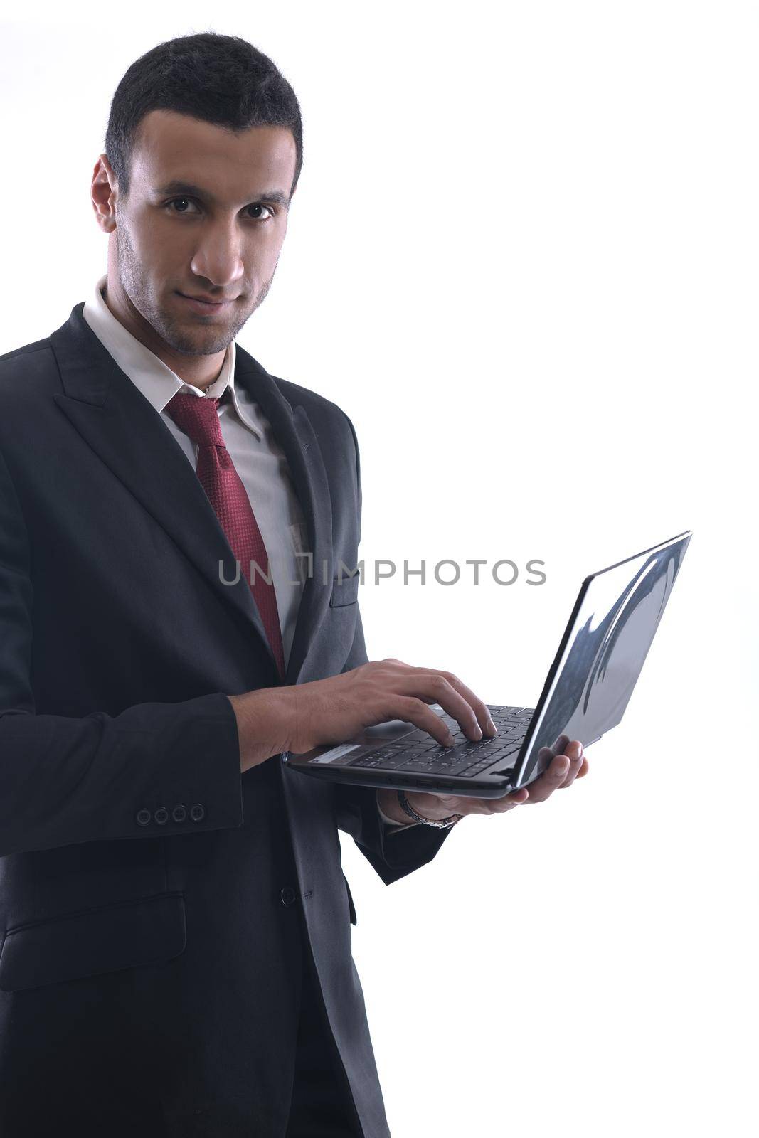 Smiling business man hold and work on mini laptop comuter   Isolated on white background in studio