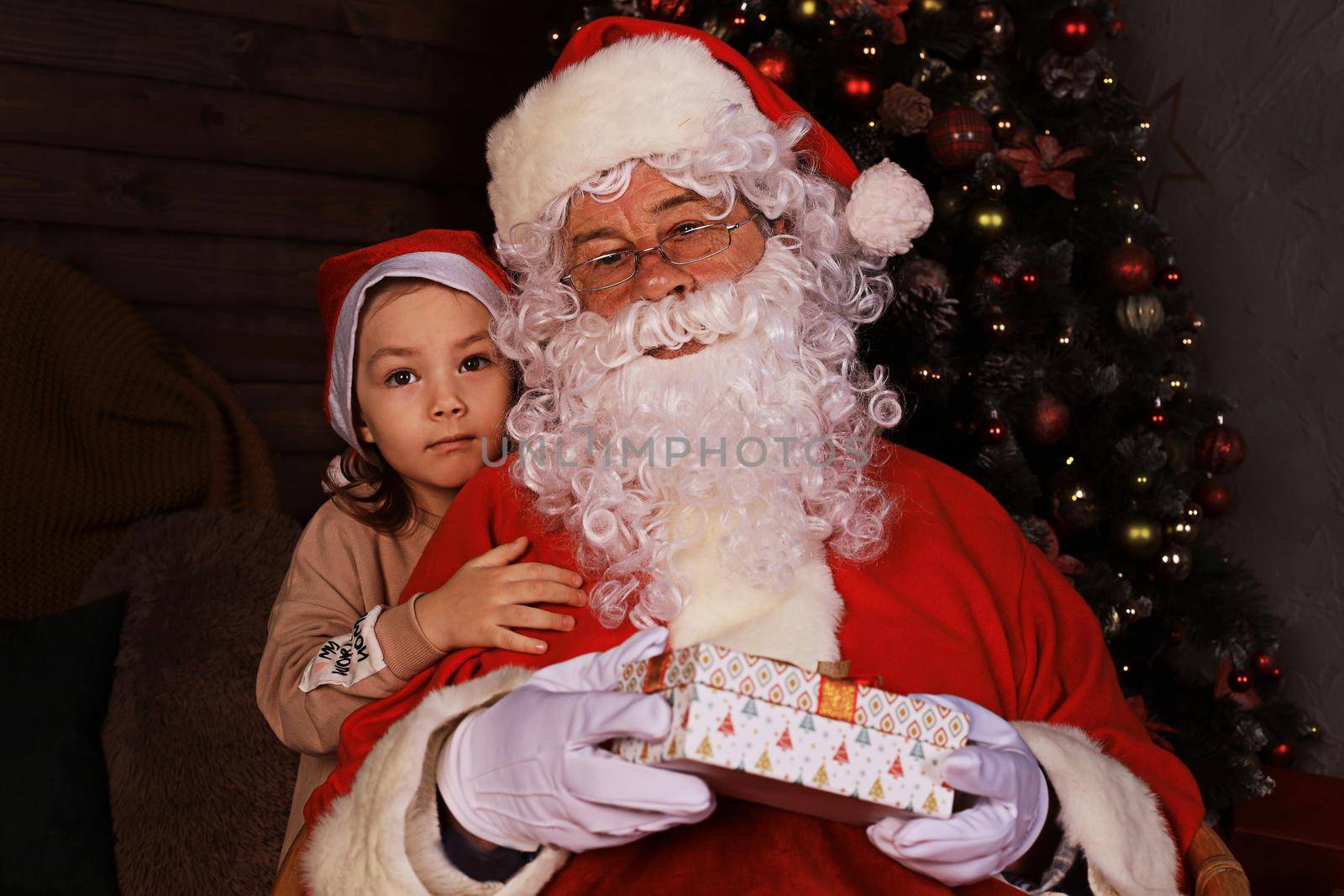 Santa Claus and child at home. Christmas gift. Family holiday concept. by tsyhun