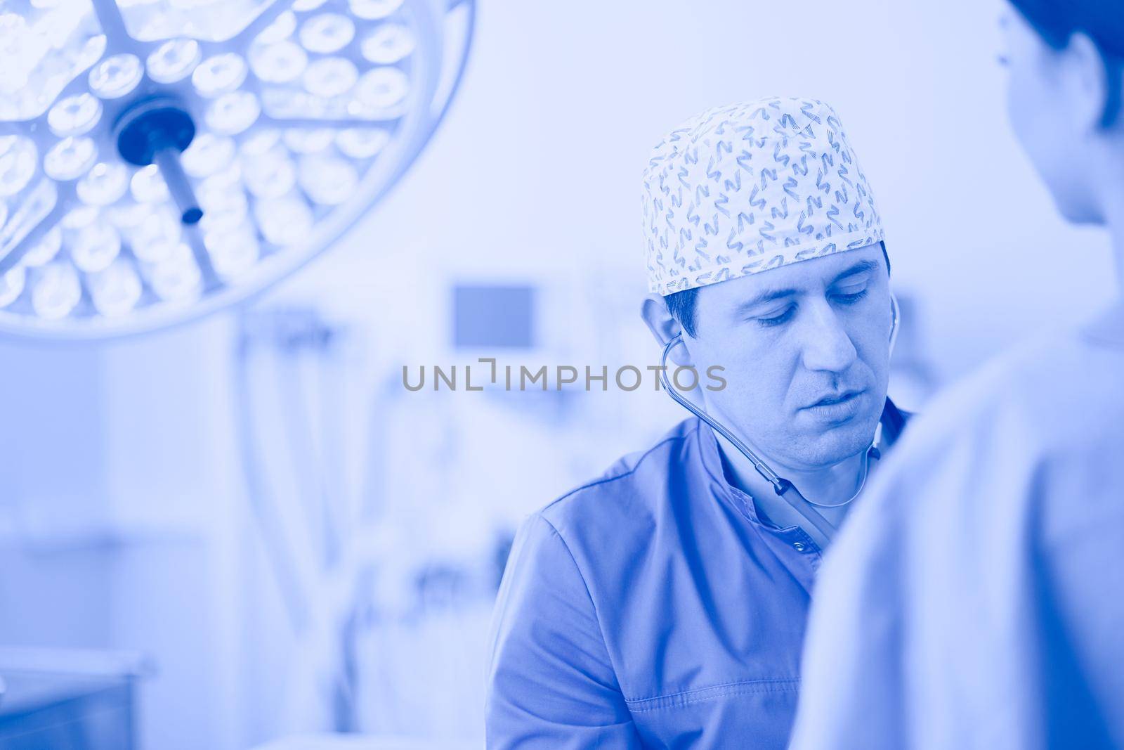Man surgeon at work in operating room.
