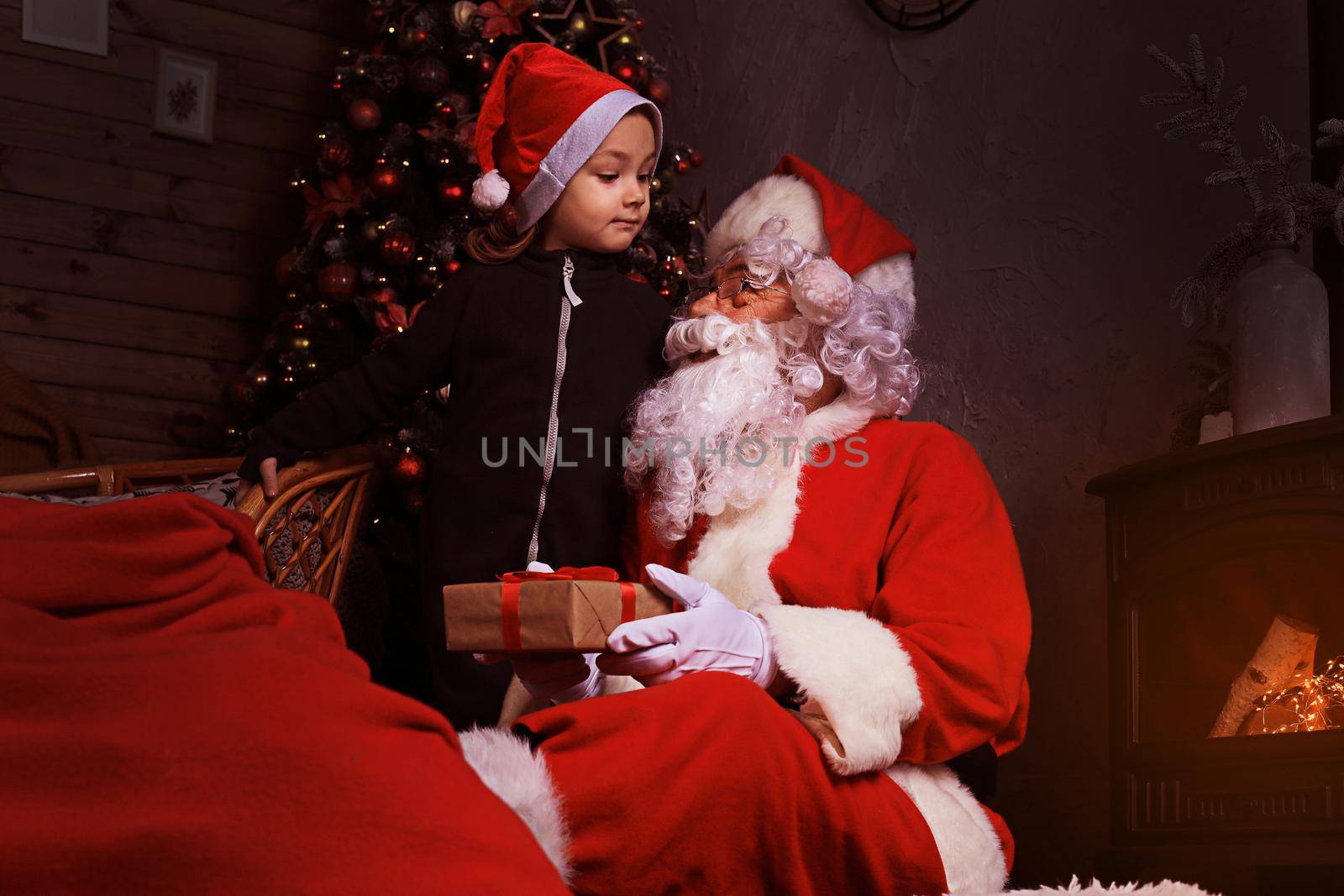 Santa Claus and child at home. Christmas gift. Family holiday concept