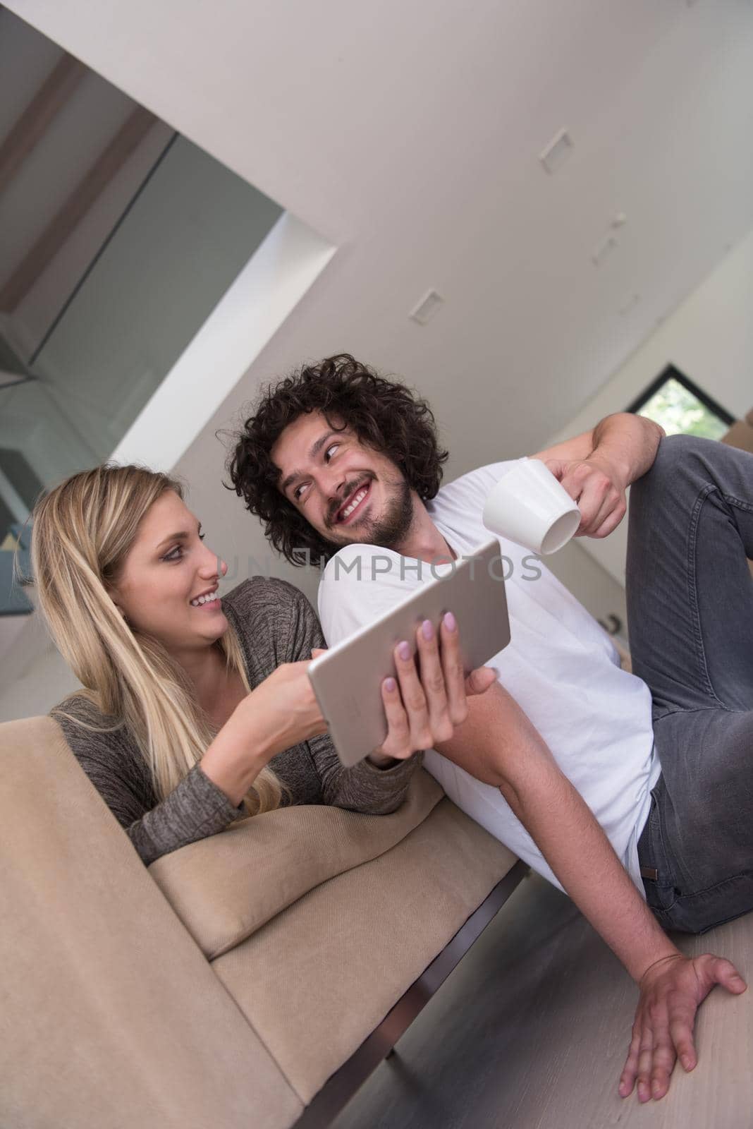 couple relaxing at  home with tablet computers by dotshock