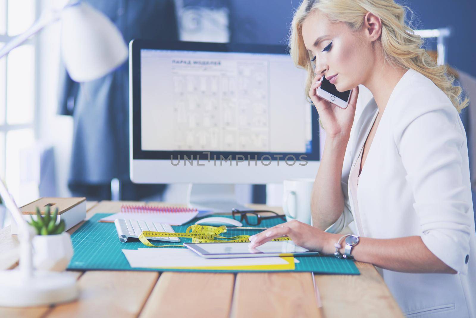 Fashion designer woman working on her designs in the studio